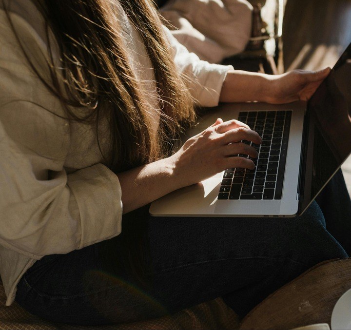 Two people working together on a presentation on a laptop